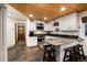 Well-lit kitchen featuring white cabinets, granite countertops, stainless steel appliances, and a tiled floor at 384 Blue Ridge Rd, Breckenridge, CO 80424