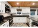 Updated kitchen with white cabinets, granite counters, stainless appliances, and natural light from the windows at 384 Blue Ridge Rd, Breckenridge, CO 80424