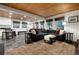 Living room with wood ceiling, carpeted seating area and access to the kitchen, dining and outdoor deck at 384 Blue Ridge Rd, Breckenridge, CO 80424