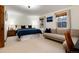 Main bedroom with bed, couch, two windows and wood accents around the doors and windows at 384 Blue Ridge Rd, Breckenridge, CO 80424
