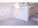 Spacious carpeted basement area with bright walls and a doorway to another room at 6190 Ivy St, Commerce City, CO 80022