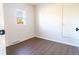 Empty bedroom showcasing wood-look flooring, a bright window, and fresh paint at 6190 Ivy St, Commerce City, CO 80022