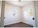 Empty bedroom showcasing wood-look flooring, and two bright windows at 6190 Ivy St, Commerce City, CO 80022