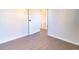 Clean bedroom showcasing wood-look flooring and neutral paint at 6190 Ivy St, Commerce City, CO 80022