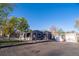 Exterior view of a single-story home with a two-car garage on a sunny day at 6190 Ivy St, Commerce City, CO 80022