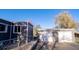 Detached two car garage and home with fenced yard and landscaping at 6190 Ivy St, Commerce City, CO 80022