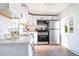 Updated kitchen featuring white cabinets, stainless steel appliances, and modern fixtures; perfect for culinary enthusiasts at 6190 Ivy St, Commerce City, CO 80022