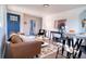 Cozy living room featuring a blue front door, stylish decor, and an inviting open floor plan; perfect for entertaining at 6190 Ivy St, Commerce City, CO 80022
