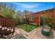 Backyard features brick accents, a garden area, and a charming walkway that enhances its appeal at 1239 N Lafayette St, Denver, CO 80218