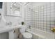 Bright white bathroom with tiled shower, tub, and vintage-style sink at 1239 N Lafayette St, Denver, CO 80218