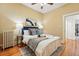 Bedroom with hardwood floors, neutral paint, queen bed, and a ceiling fan at 1239 N Lafayette St, Denver, CO 80218