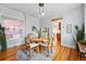 Elegant dining room featuring a round table, stylish chairs, hardwood floors, and a window for natural light at 1239 N Lafayette St, Denver, CO 80218