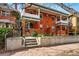 Charming brick home featuring dual front porches, tidy landscaping, and prominent street numbers on a sunny day at 1239 N Lafayette St, Denver, CO 80218