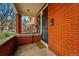 Inviting covered front porch with brick columns, and an iron security door providing charm and security at 1239 N Lafayette St, Denver, CO 80218