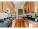 Galley kitchen features wood cabinets, granite countertops, stainless appliances and hardwood floors at 1239 N Lafayette St, Denver, CO 80218