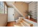 Mudroom with stairs, closet shelving, wood paneling and a back door at 1239 N Lafayette St, Denver, CO 80218