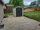 Backyard with a storage shed, concrete patio, and wooden fence at 2597 S Dillon St, Aurora, CO 80014