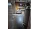 Unfinished basement space with exposed utilities and wooden shelves. Ready for personalized design and upgrades at 2597 S Dillon St, Aurora, CO 80014