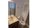 Compact bathroom with a vanity, toilet, and shower, designed for functionality and practicality at 2597 S Dillon St, Aurora, CO 80014