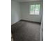 A bright bedroom featuring a window providing natural light and a view of the outdoors at 2597 S Dillon St, Aurora, CO 80014