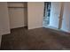 Bedroom features carpeted floors, closet, and an entry door at 2597 S Dillon St, Aurora, CO 80014