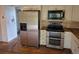 Kitchen featuring stainless steel appliances, custom cabinets, and hardwood floors at 2597 S Dillon St, Aurora, CO 80014