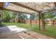 Large backyard features a covered patio, lush lawn, shed, and a wood fence at 6579 Ingalls St, Arvada, CO 80003