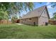 Spacious backyard with a well-maintained lawn, patio, and a wood privacy fence at 6579 Ingalls St, Arvada, CO 80003