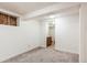 Finished basement area featuring neutral carpet and an entrance to an adjacent bathroom at 6579 Ingalls St, Arvada, CO 80003