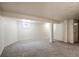 Finished basement featuring carpeted floors and structural support beams at 6579 Ingalls St, Arvada, CO 80003
