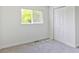 Carpeted bedroom with a window view and double door closet at 6579 Ingalls St, Arvada, CO 80003