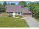 Aerial view of a charming home with a well-manicured lawn and attached garage at 6579 Ingalls St, Arvada, CO 80003
