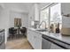 Modern kitchen featuring white cabinets, stainless steel appliances, and a dining area at 6579 Ingalls St, Arvada, CO 80003