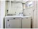Bright laundry room complete with a Maytag washer and dryer and wire shelving at 6579 Ingalls St, Arvada, CO 80003