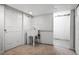 Laundry room features utility sink with shelving above and a doorway at 6579 Ingalls St, Arvada, CO 80003