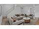Comfortable living room featuring stylish furniture, a neutral color palette, and staircase at 6579 Ingalls St, Arvada, CO 80003
