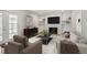 Cozy living room featuring a fireplace, modern decor, and plenty of natural light at 6579 Ingalls St, Arvada, CO 80003