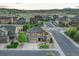 Scenic aerial view of a well-planned community showcasing beautiful homes and green spaces against a mountain backdrop at 7310 Blue Water Dr, Castle Rock, CO 80108