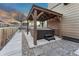 The backyard features a hot tub under a wooden pergola with string lights at 7310 Blue Water Dr, Castle Rock, CO 80108