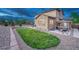 Picturesque backyard featuring lush green grass, a stone-lined garden, and a relaxing hot tub area at 7310 Blue Water Dr, Castle Rock, CO 80108