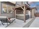 A backyard patio features a hot tub under a wooden pergola and outdoor seating at 7310 Blue Water Dr, Castle Rock, CO 80108