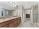 Bathroom boasts double sinks, granite countertops, walk-in shower, and natural lighting from a window at 7310 Blue Water Dr, Castle Rock, CO 80108