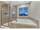 Luxurious bathroom featuring a separate shower, tub, and a window with natural light at 7310 Blue Water Dr, Castle Rock, CO 80108
