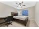 Comfortable bedroom featuring a ceiling fan, neutral carpeting, and a large window for natural light at 7310 Blue Water Dr, Castle Rock, CO 80108