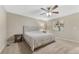 Cozy bedroom with neutral tones, ceiling fan, a queen-sized bed and bedside tables with decor at 7310 Blue Water Dr, Castle Rock, CO 80108