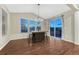 Dining area offering wood floors, a serving island, large windows and backyard access at 7310 Blue Water Dr, Castle Rock, CO 80108