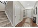 Inviting entryway features hardwood floors, staircase, and natural light, creating a warm welcome at 7310 Blue Water Dr, Castle Rock, CO 80108