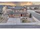 Aerial view of a beautiful two-story home with a three-car garage, well-manicured lawn, and charming curb appeal at 7310 Blue Water Dr, Castle Rock, CO 80108
