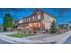 Attractive two-story home with a covered porch, manicured lawn, stone accents, and a convenient two-car garage at 7310 Blue Water Dr, Castle Rock, CO 80108
