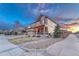 Beautiful two-story home with a well-manicured lawn, fenced yard, and inviting front porch at 7310 Blue Water Dr, Castle Rock, CO 80108